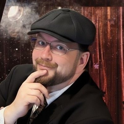 Vince Wilson, magician and mentalist, in a flat cap and suit